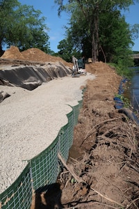 Heavy construction machinery fills temporary barriers with stone along the access road to a dam in Tionesta, Pennsylvania June 25, 2020.