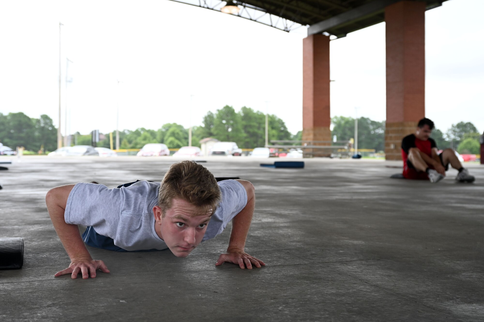 Airman 1st Class Isaiah Miller, 19th Airlift Wing Public Affairs mass communications apprentice, does a push-up during a Vital 90 course as part of Wingman Day at Little Rock Air Force Base.