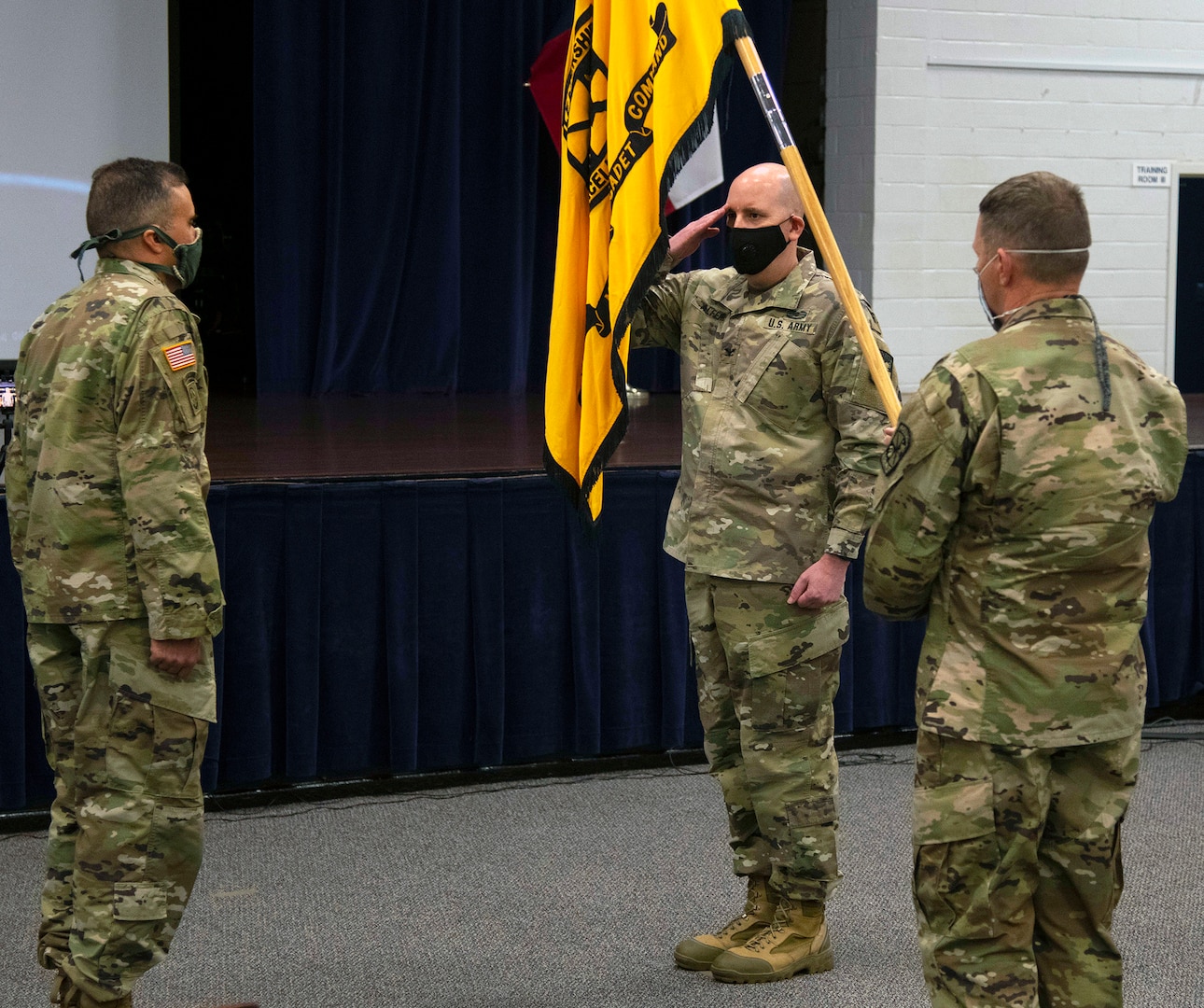 Col. Chris S. Alfeiri (right), departing 5th Brigade commander, salutes the colors, while Col. Mark A. Olsen (left), incoming commander, looks on June 23.