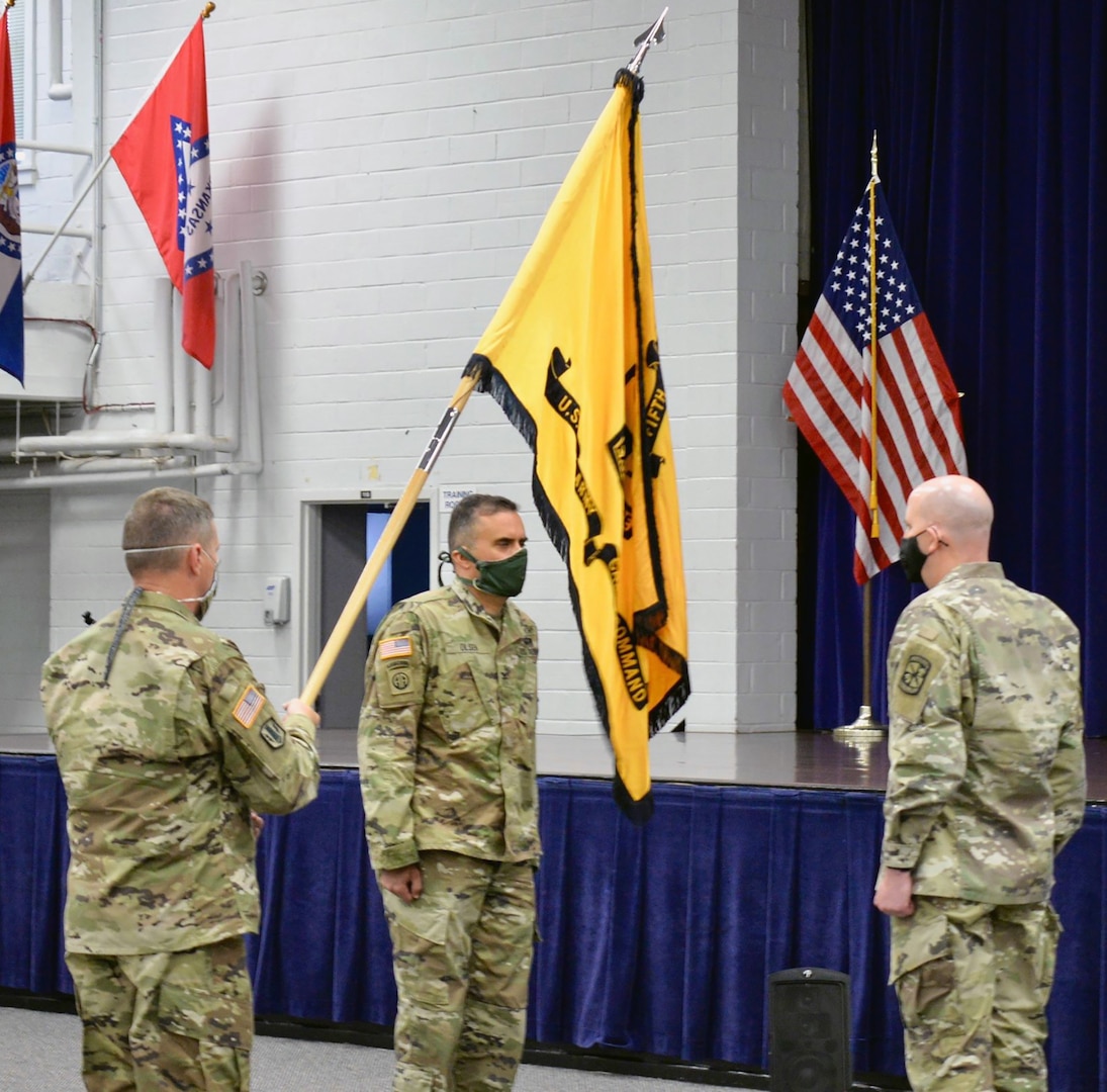 5th Brigade Command Sgt. Maj. George B. Bunn (left) dips the colors to the outgoing 5th Brigade commander, Col. Chris S. Alfeiri (right), while Col. Mark A. Olsen, incoming commander (center) looks on June 23.