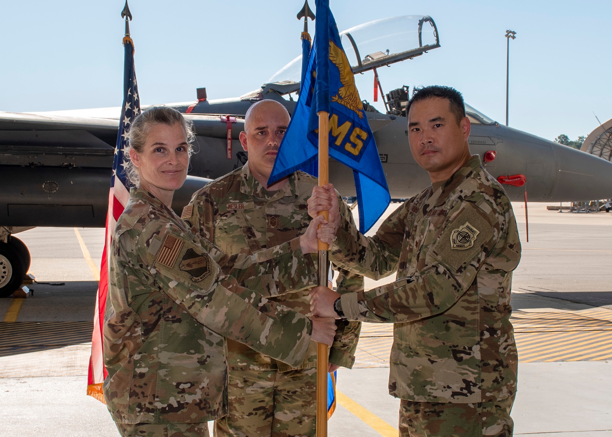 Col. Leah R. Fry, 4th Maintenance Group commander (left), passes the guidon to Maj. Ryan B. Hudson (right), as Hudson assumes command of the 4th Equipment Maintenance Squadron during a change of command ceremony at Seymour Johnson Air Force Base, North Carolina, June 26, 2020.