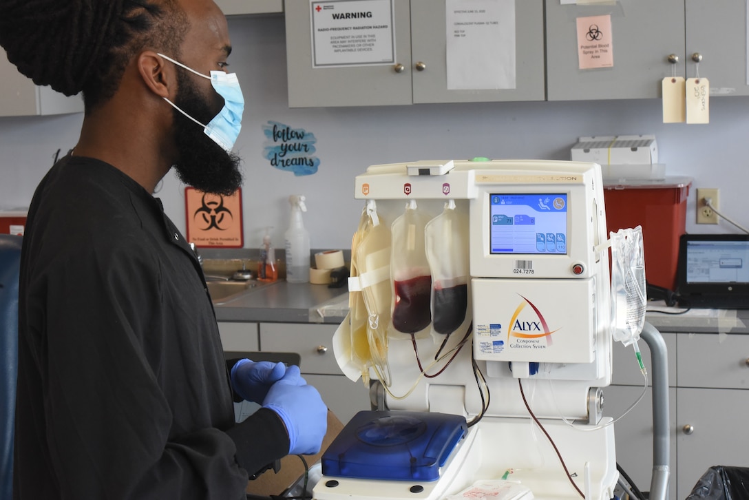 A technician watches as a machine separates whole blood into three components.