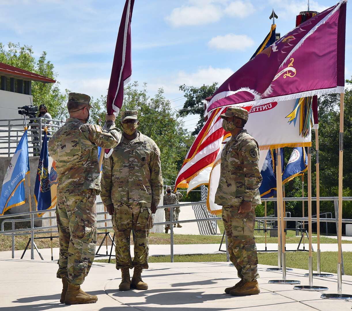 Gen. James C. McConville, Chief of Staff of the U.S. Army, passes the flag to the U.S. Army Surgeon General and commanding general, U.S. Army Medical Command, Lt. Gen. R. Scott Dingle, in an assumption of command ceremony at Joint Base San Antonio-Fort Sam Houston June 24.