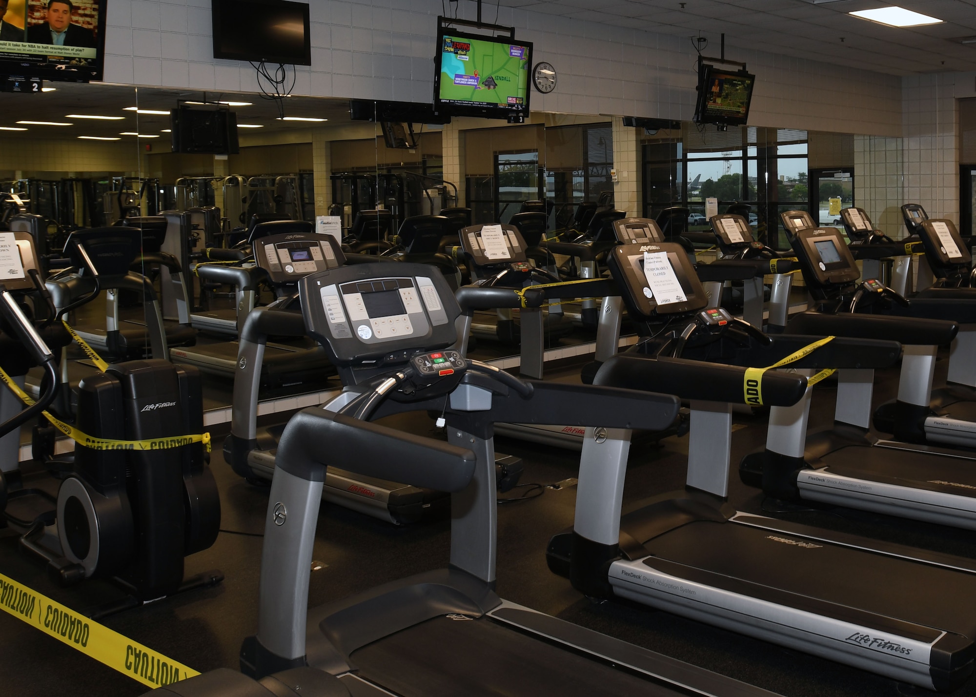 Caution tape drapes over gym equipment to help customers follow social distancing guidelines June 19, 2020, at McConnell Air Force Base, Kansas. The facility opened with a few noticeable changes that allow Airmen to bring an element of fitness into their daily routines. (U.S. Air Force photo by Tech. Sgt. Jennifer Stai)