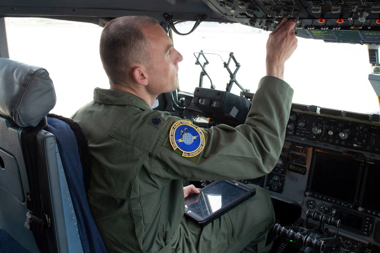 Lt. Col. Coningsby J. Burdon, AMC 43 OSS/DO, makes preparations on a C-17 Globemaster III during a training exercise at Pope Field, North Carolina.