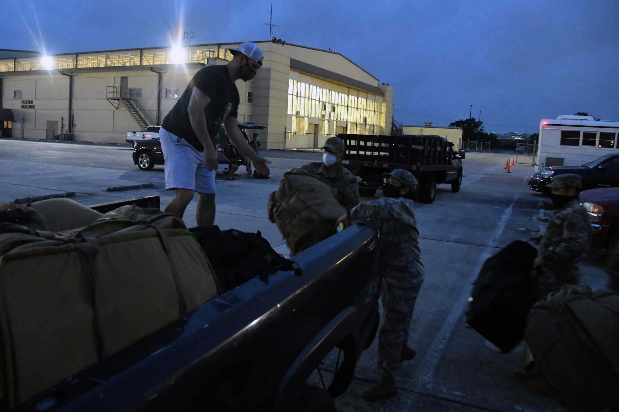 33rd Civil Engineer Squadron Reserve Citizen Airmen, Senior Master Sgt. Stephen Johnson, fire chief (left), Senior Airman Rene Ruiz, firefighter, and Master Sgt. Jane Cummings, unit deployment manager, load bags into a pickup as squadron members prepare to deploy to Southwest Asia June 28, 2020, at Joint Base San Antonio-Lackland, Texas.