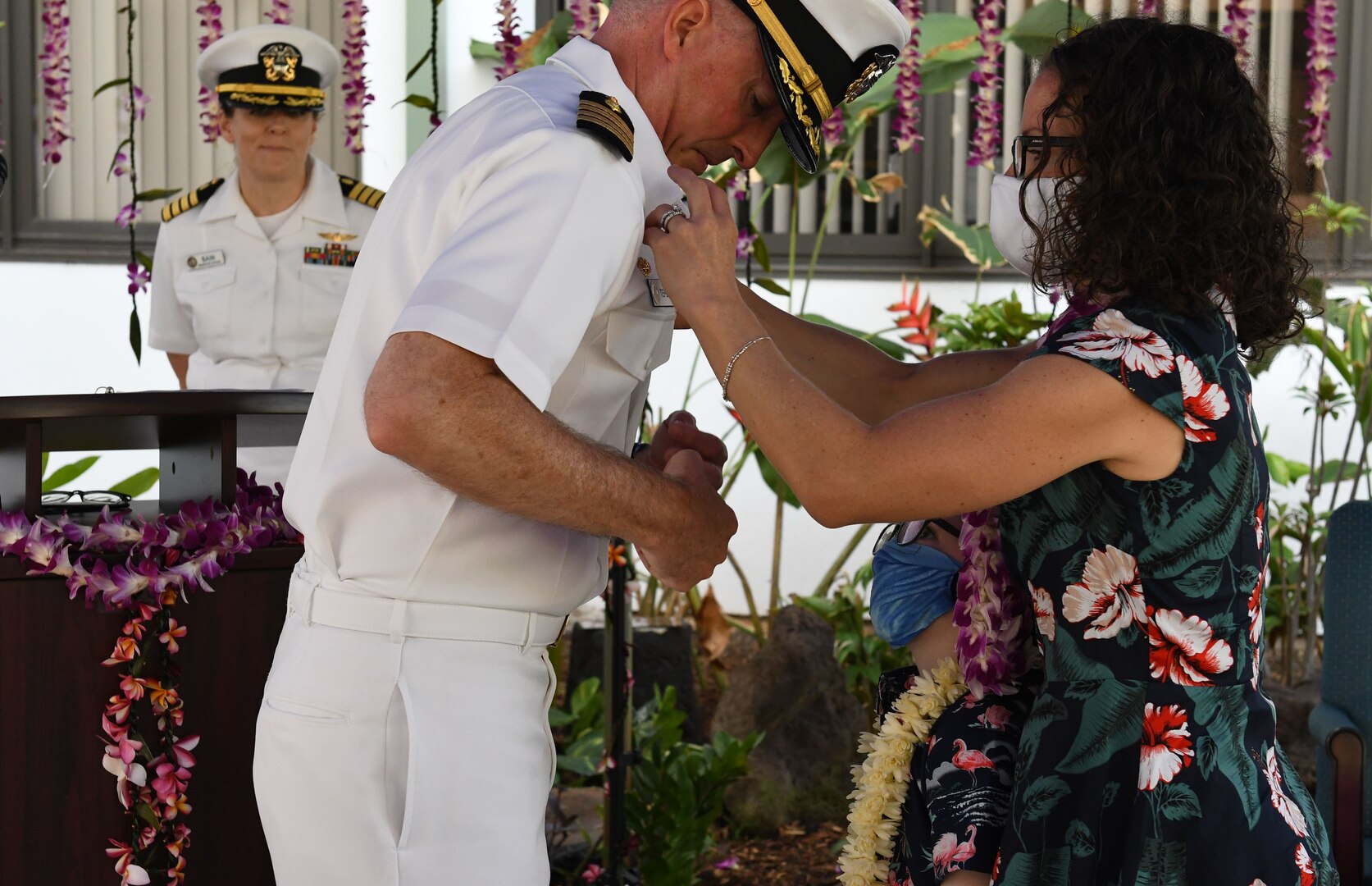 Captain Christopher Tepera receives the command pin from his wife.