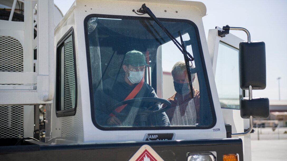 Mike Nelson, training adviser for Large Capacity Refuel Vehicle manufacturer Stephens Pneumatics, trains Daniel Beasley, a Fuels Distribution Service Operator, 412th Logistics Readiness Squadron, on the new vehicles operation at Edwards Air Force Base, California, June 26. (Air Force photo by Giancarlo Casem)