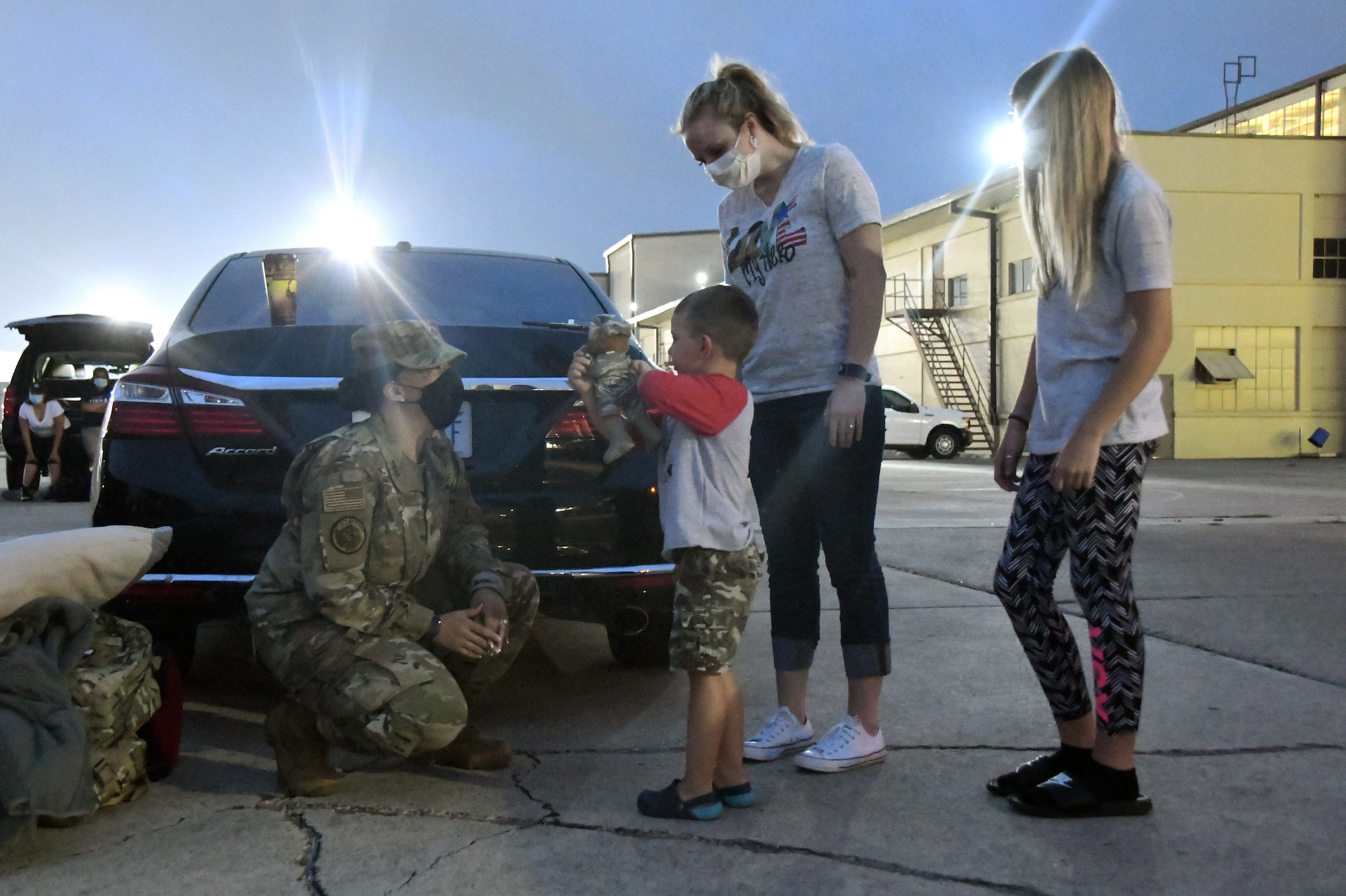 Maj. Leigh Barker, 433rd Civil Engineer Squadron commander, talks to Kason Weertman, son of Master Sgt. Andrew Weertman, 433rd CES assistant chief of operations, while his mother, Ali, and sibling, Abby, stand nearby June 28, 2020, at Joint Base San Antonio-Lackland, Texas.