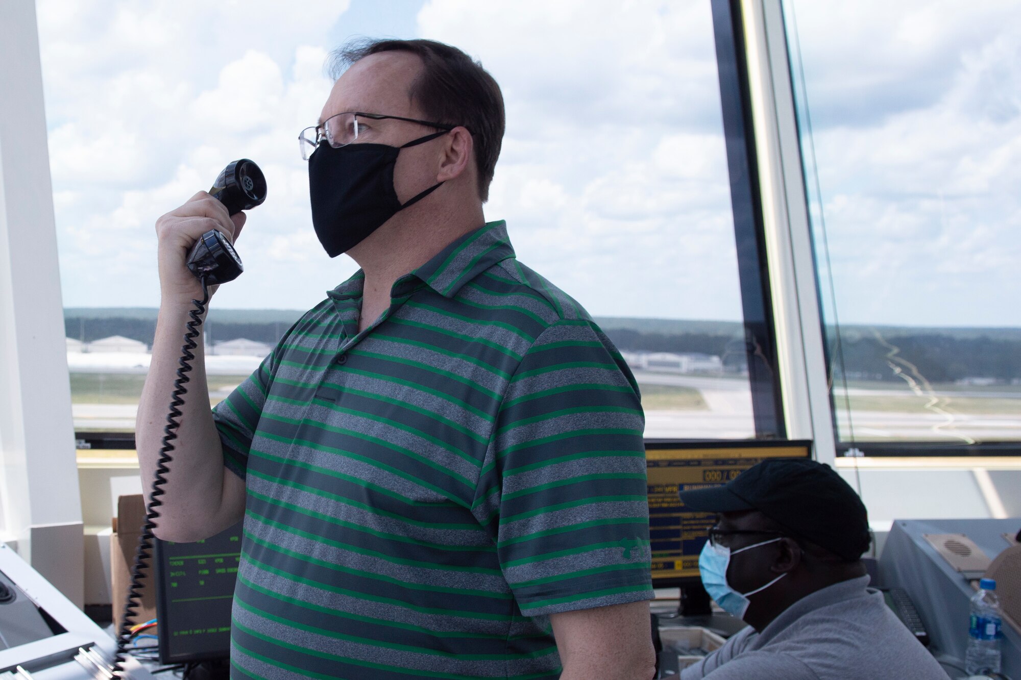 The Pope Field air traffic control tower provides information to an aircraft during a training flight.