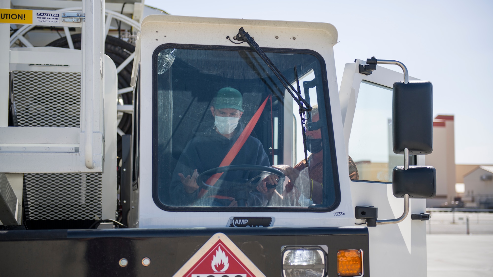 Mike Nelson, training adviser for Large Capacity Refuel Vehicle manufacturer Stephens Pneumatics, trains Daniel Beasley, a Fuels Distribution Service Operator, 412th Logistics Readiness Squadron, on the new vehicles operation at Edwards Air Force Base, California, June 26. (Air Force photo by Giancarlo Casem)