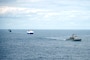 USS Vella Gulf (CG 72), right, the vehicle carrier MV Resolve, center, and the Military Sea Lift Command (MSC) roll-on roll-off cargo ship USNS Benavidez (T-AKR 306) steam in formation