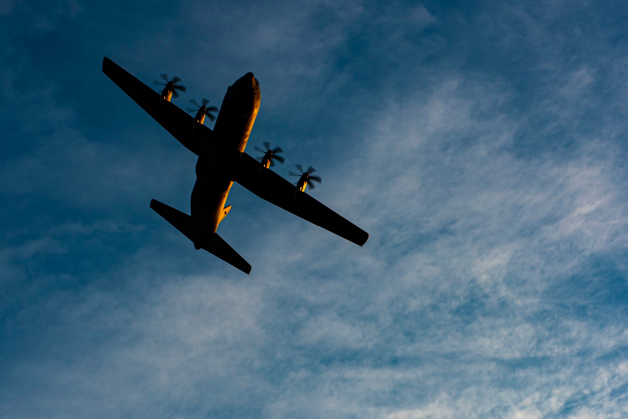 A C-130J Super Hercules flies over the flightline at Dyess Air Force Base, Texas, June 3, 2020. The 317th Airlift Wing recently finished the first round of the new 4/12 C-130 deployment cycle. The 4/12 deployment cycle allows an entire C-130J airlift squadron and their associated maintenance unit to deploy for four months, which allows Airmen a 12 month dwell time at home station before the next scheduled deployment. (U.S. Air Force photo by Airman 1st Class Colin Hollowell)