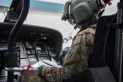 An Indiana National Guard UH-60 Black Hawk pilot conducts preflight checks before a combat search-and-rescue training exercise in Miami County, Indiana, June 18, 2020. The mock scenario utilized a UH-60 Black Hawk helicopter from the Gary Army Aviation Support Facility and multiple A-10C Thunderbolt II fighter jets from the 122nd Fighter Wing, Fort Wayne, to retrieve personnel from a downed aircraft inside hostile territory.