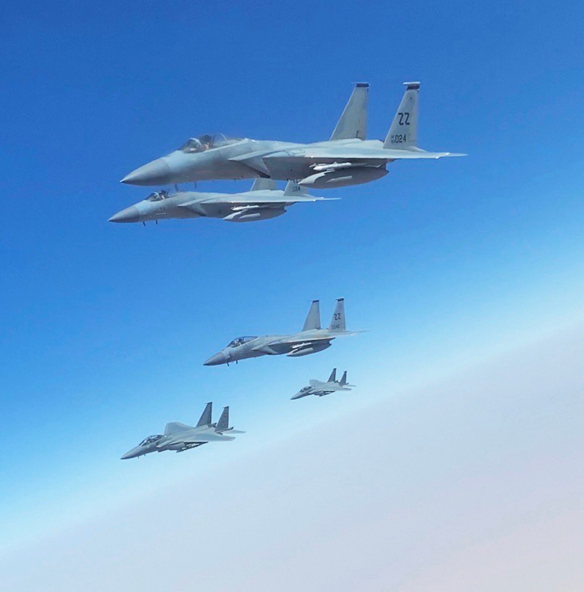 An F-15C fighter jet from the 44th Expeditionary Fighter Squadron, Prince Sultan Air Base, Kingdom of Saudi Arabia, flys in formation with two F-15SA Royal Saudi Air Force jets from the 6th Squadron, King Khalid Air Base, Kingdom of Saudi Arabia and a KC-135 Stratotanker from Al Udeid, Qutar, during an integrated sortie flight in the Kingdom of Saudi Araibia, June 25, 2020. The integrated sorties allow U.S. and RSAF pilots to famiiliaraize themselves with communications and mission planning procedures. It also allows them to maintain readiness for longer mission capabilities.