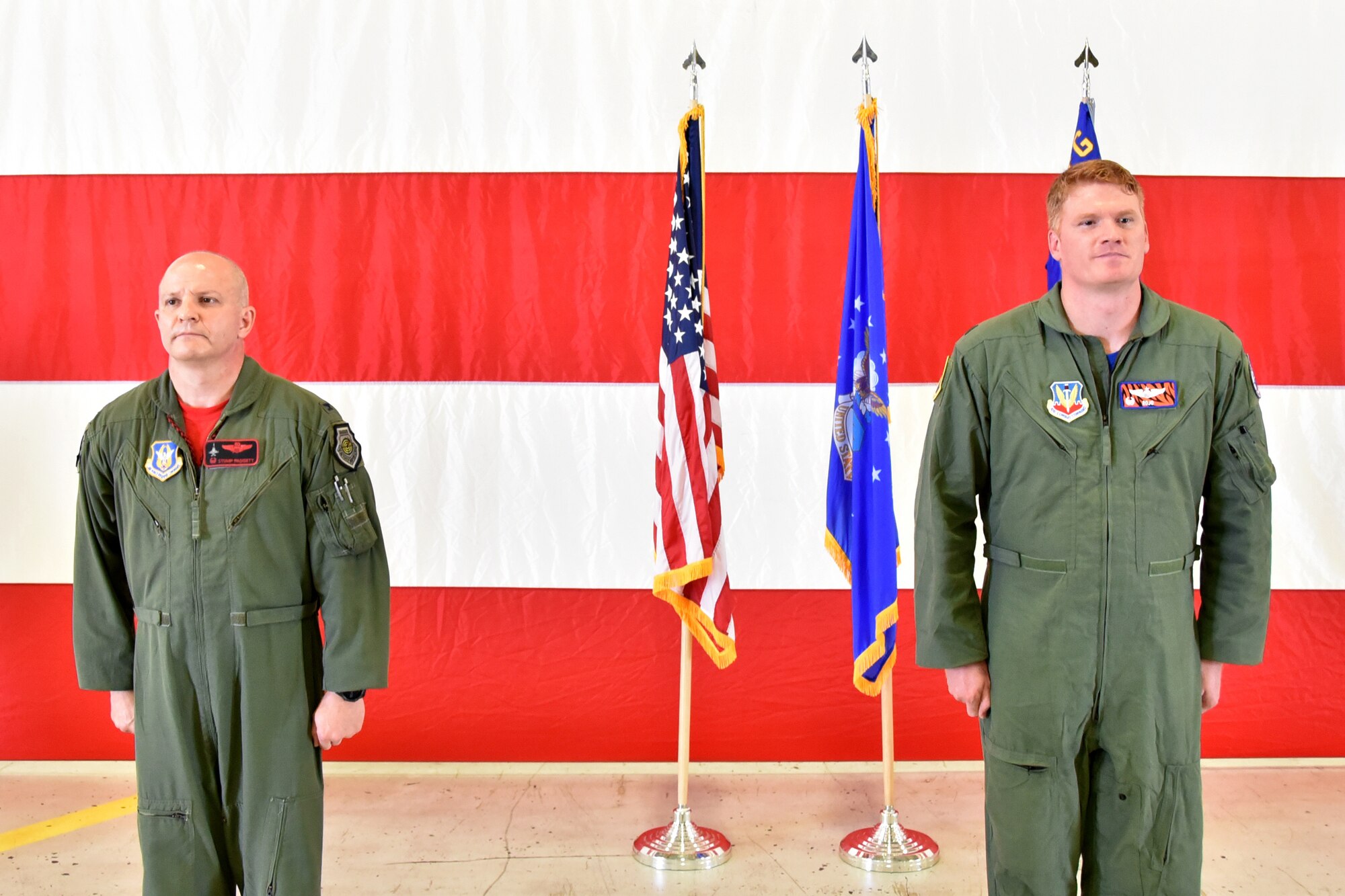 Col. Joshua Padgett, 301st Fighter Wing Operations Group commander, and Maj. Ryan “Rojo” Busbey, 24th Fighter Squadron commander, stand during the 24th FS assumption of command ceremony, June 26, 2020, at Naval Air Station Joint Reserve Base Fort Worth, Texas. Busbey is responsible for leading a team of 190 active duty Airmen consisting F-16 pilots, maintainers, medical, communications, and administrative support personnel. (U.S. Air Force photo by Staff Sgt. Randall Moose)