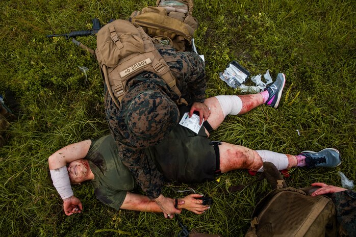 A U.S. Navy corpsman treats a patient during a 10-mile trauma run at Camp Lejeune, N.C, June 17.