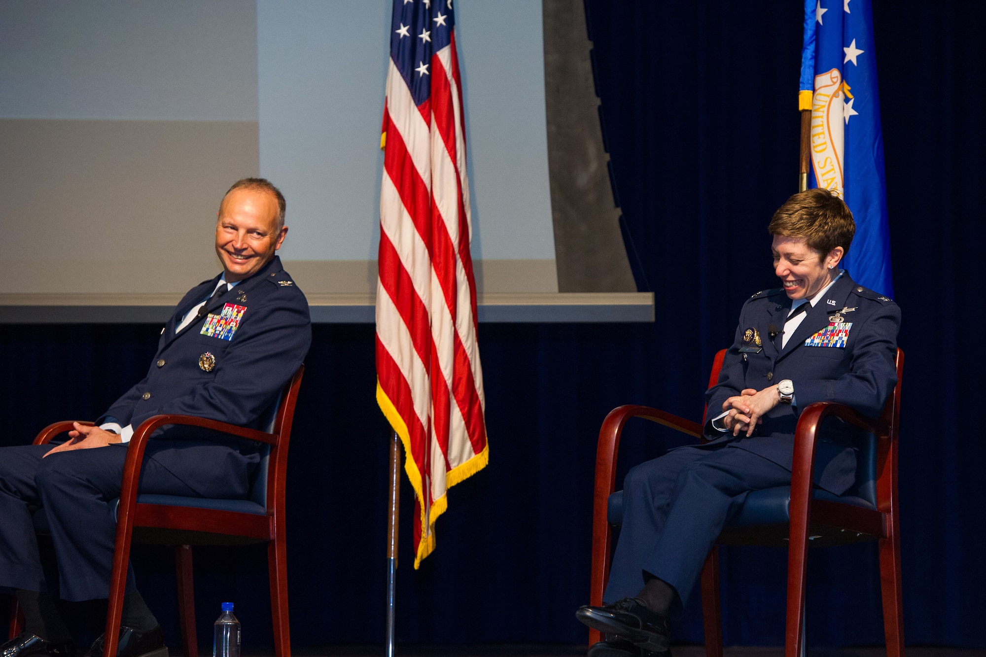 Outgoing commander Col. Chad Hartman (left) shares a laugh with incoming commander Col. Katharine Barber (right) during the Air Force Technical Applications Center’s Change of Command ceremony at Patrick AFB, Fla., June 30, 2020.  (U.S. Air Force photo by Amanda Ryrholm)