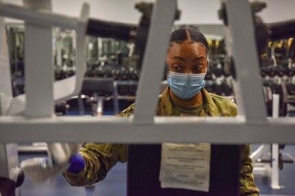 Staff Sgt. Rondashia Singleton, NCO in charge of the fitness center assigned to the 628th Force Support Squadron, deep cleans a piece of equipment in the Airbase Fitness Center at Joint Base Charleston, S.C., June 26, 2020. Members of the 628th FSS use sanitizing solution on all surfaces that people touch on a regular basis and have created parameters to reduce the spread of COVID-19 to ensure that JB Charleston continues to restore readiness.