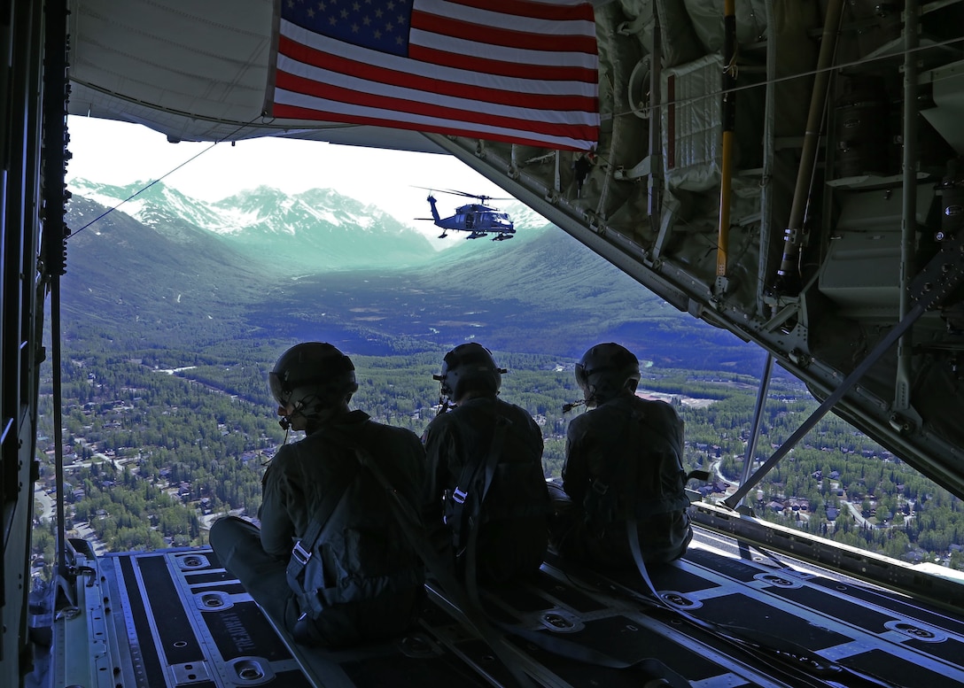 Alaska Air National Guard Loadmasters aboard a HC-130J Combat King II observe an HH-60 Pave Hawk as it prepares for an aerial refueling. The 176th Wing conducted the first of the flyovers for Alaska. The Salute to Alaska flyovers were an approved training mission and part of the Air Force Salutes initiative designed to show appreciation to the heroes around the world battling the pandemic, and to lift morale in communities across America. (U.S. Navy photo by Mass Communication Specialist 3rd Class Victoria Granado/Released)