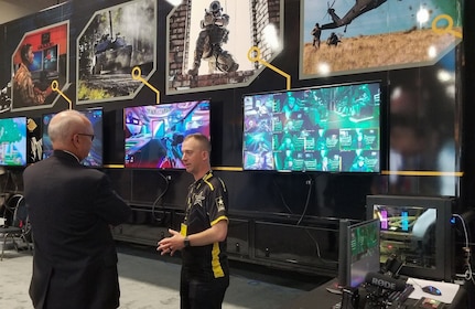 Sgt. 1st Class Christopher Jones (center), a member of the U.S. Army Recruiting Command's esports team, speaks in front of the team's semitrailer, which has gaming stations inside of it, during the Association of the U.S. Army's Annual Meeting and Exposition in Washington, D.C., Oct. 14, 2019. The command plans to create a cyber esports team and roll out autonomous recruiting operations, which will increase the mobility of recruiters with a larger social media presence.