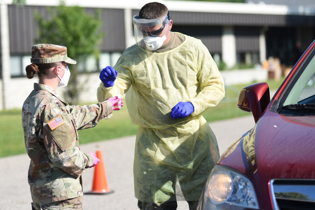 Soldiers conduct drive-thru COVID-19 testing.