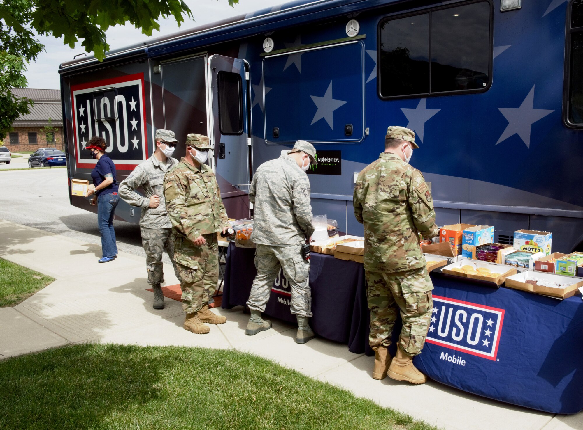 Airmen line up at the mobile The United Services Organization to get snacks and drinks at Grissom Air Reserve Base, Indiana June 06, 2020. The USO provided games and food for airmen on their lunch break during the June unit training assembly. (U.S. Air Force photo/Tech. Sgt. Jami Lancette)