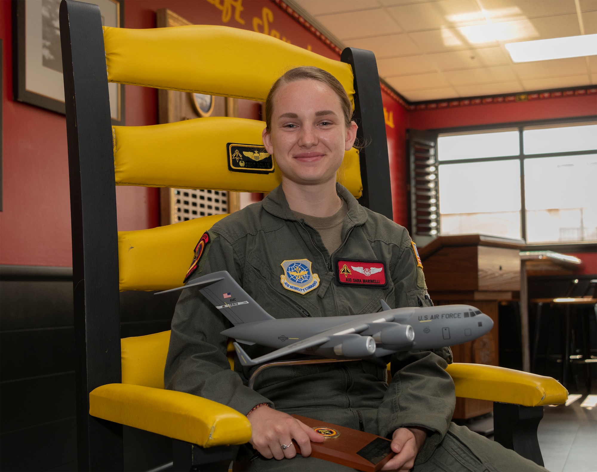 U.S. Air Force Airman 1st Class Sara Marinelli, 21st Airlift Squadron loadmaster, holds a model of a C-17 Globemaster III, June 23, 2020, at Travis Air Force Base, California. Marinelli was the 60th Air Mobility Wing Warrior of the Week for June 21-27, 2020.  The program recognizes outstanding Airmen who have made significant contributions to their unit. (U.S. Air Force photo by Heide Couch)