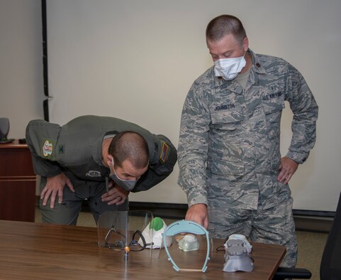 U.S. Air Force Col. Zachery Jiron, left, 60th Air Mobility Wing vice commander, and Maj. Geoffrey Johnston, 60th Dental Squadron prosthodontist, look at personal protection equipment during Leadership Rounds June 26, 2020, at David Grant USAF Medical Center, Travis Air Force Base, California. The Leadership Rounds program provides 60th AMW leadership an opportunity to interact with Airmen and get a detailed view of each mission performed at Travis AFB. (U.S. Air Force photo by Heide Couch)