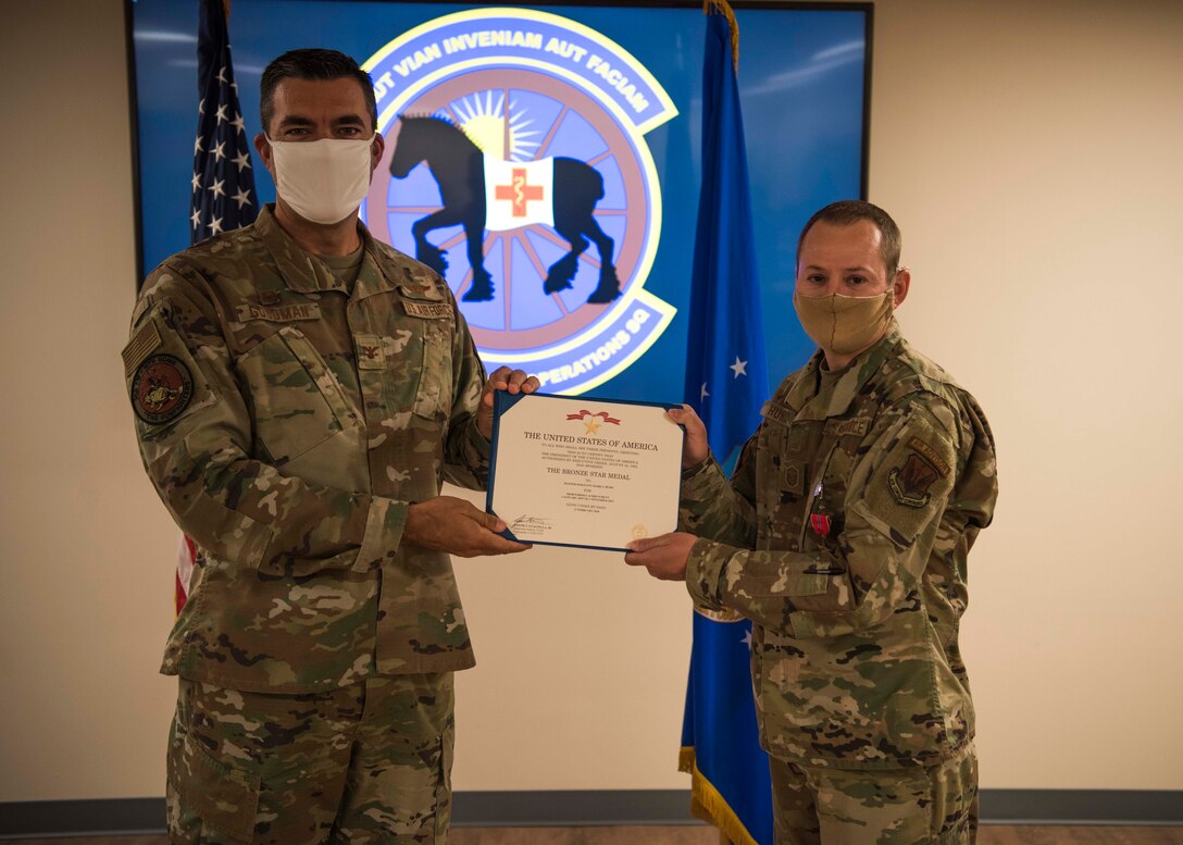 U.S. Air Force Col. Richard Goodman, 366th Fighter Wing commander, presents a Bronze Star to Master Sgt. Mark Hurd, 366th Healthcare Operations Squadron medical logistics flight chief, June 24, 2020, at Mountain Home Air Force Base, Idaho. Hurd completed 72 outside-the-wire advising missions while exposed to significant danger including indirect fire, insider threats and direct fire engagements.