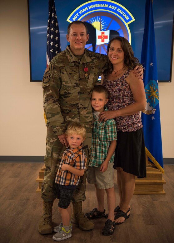 Master Sgt. Mark Hurd, 366th Healthcare Operations Squadron medical logistics flight chief, poses with his family after receiving the Bronze Star, June 24, 2020, at Mountain Home Air Force Base, Idaho. Hurd aided in the development of mission-essential training programs like Airborne Casualty Evacuation and medical model simulation classes for over 200 Air Force medics across Afghanistan.