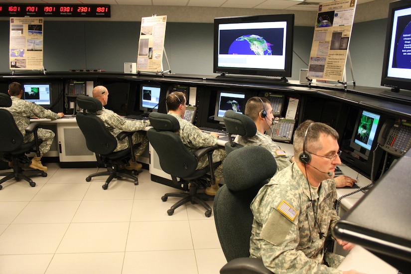 Soldiers man consoles in operations room.