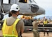 Airman guide a helicopter on a truck.