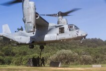 Marines with Combat Logistics Battalion (CLB) 31, 31st Marine Expeditionary Unit (MEU), attach a tire load to an MV22B Osprey tiltrotor aircraft with Marine Medium Tiltrotor Squadron 262 (Reinforced) during a helicopter support team (HST) training exercise at Kin Blue, Okinawa, Japan, June 18, 2020. The HST training was conducted to increase proficiencies in logistics tasks and enhance the ability to execute external lifts.