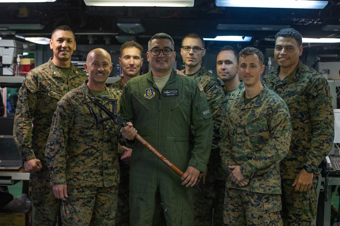 Photo of a gift presentation from a Marine commander to an Air Force captain.