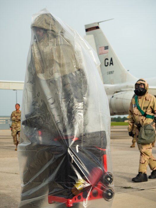 Photo shows an Airman in chem gear.