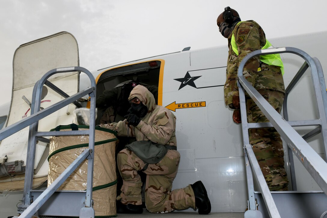 Photo shows an Airmen disposing of gear.