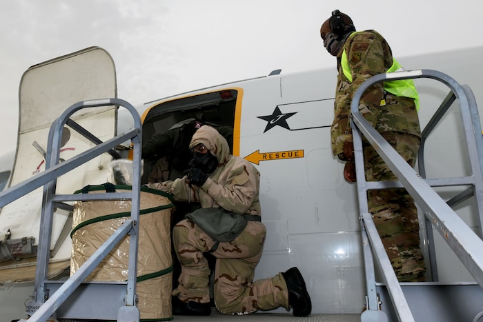 Photo shows an Airmen disposing of gear.