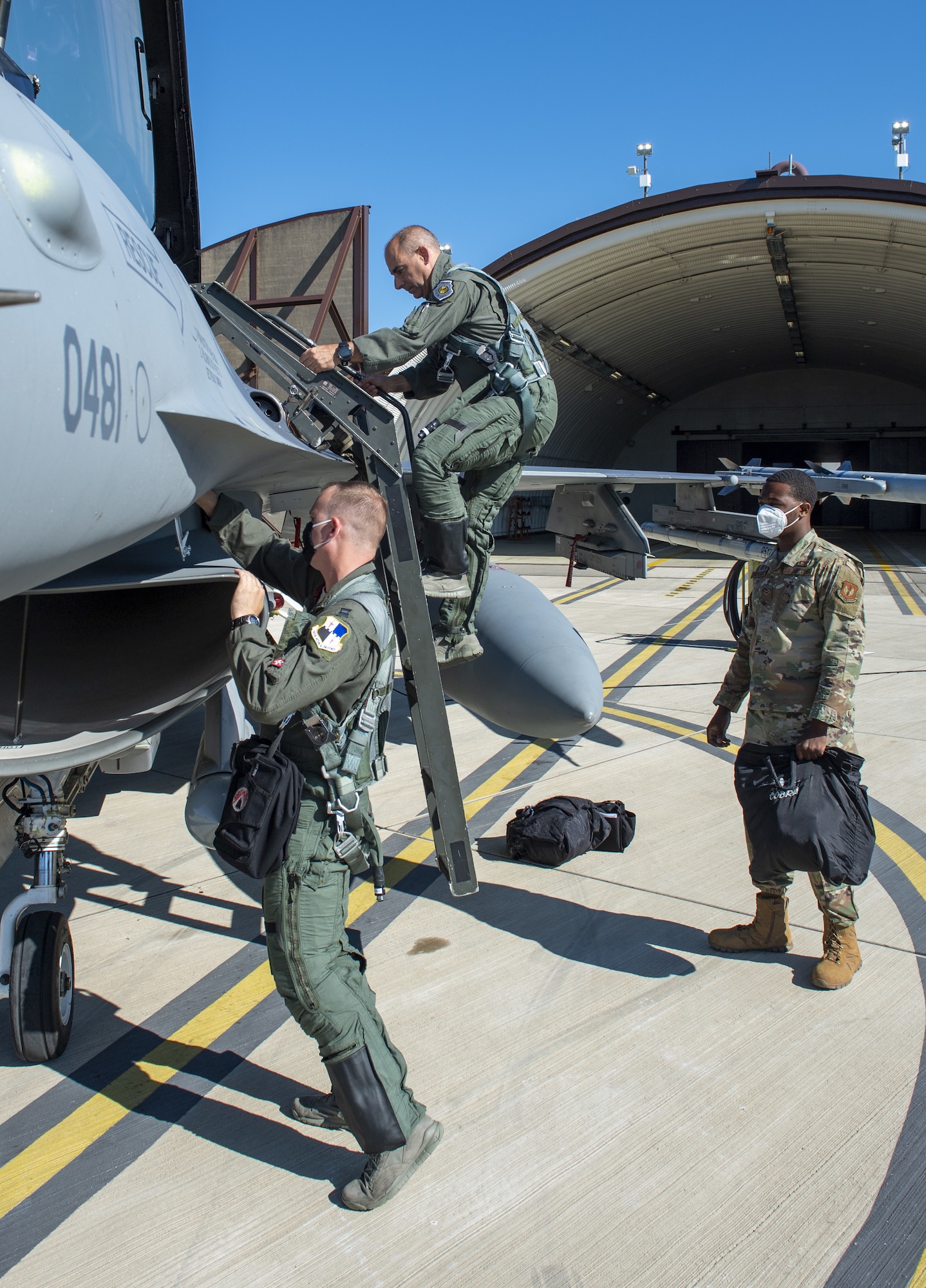 Gen. Jeff Harrigian, center, U.S. Air Forces in Europe and Air Forces Africa commander, Capt. Daniel Cook, left, 480th Fighter Squadron pilot, and Airman 1st Class Tyrek Montgomery, 52nd Aircraft Maintenance Squadron assistant dedicated crew chief, complete pre-flight procedures before participating in an Agile Combat Employment exercise on the flight line at Spangdahlem Air Base, Germany, June 25, 2020. ACE allows the U.S. to deter adversaries and win across the spectrum of conflict. (U.S. Air Force photo by Senior Airman Branden Rae)