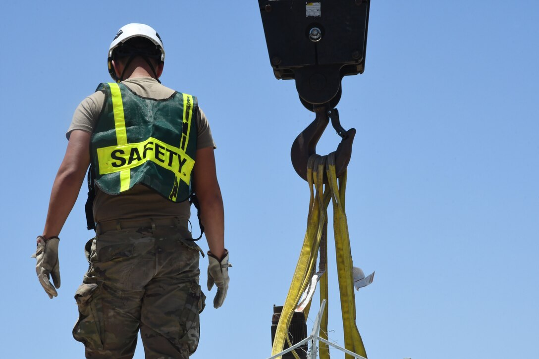 An Airman stands on a helicopter.