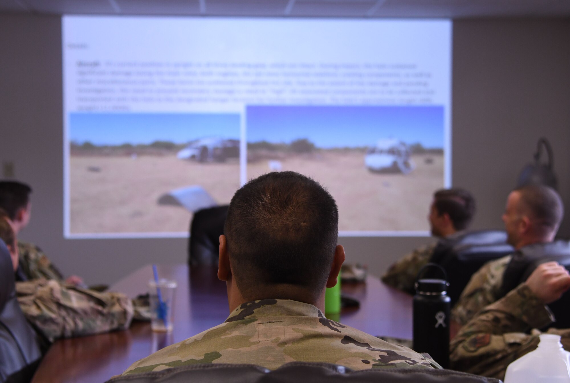 An Airman sits in a briefing.