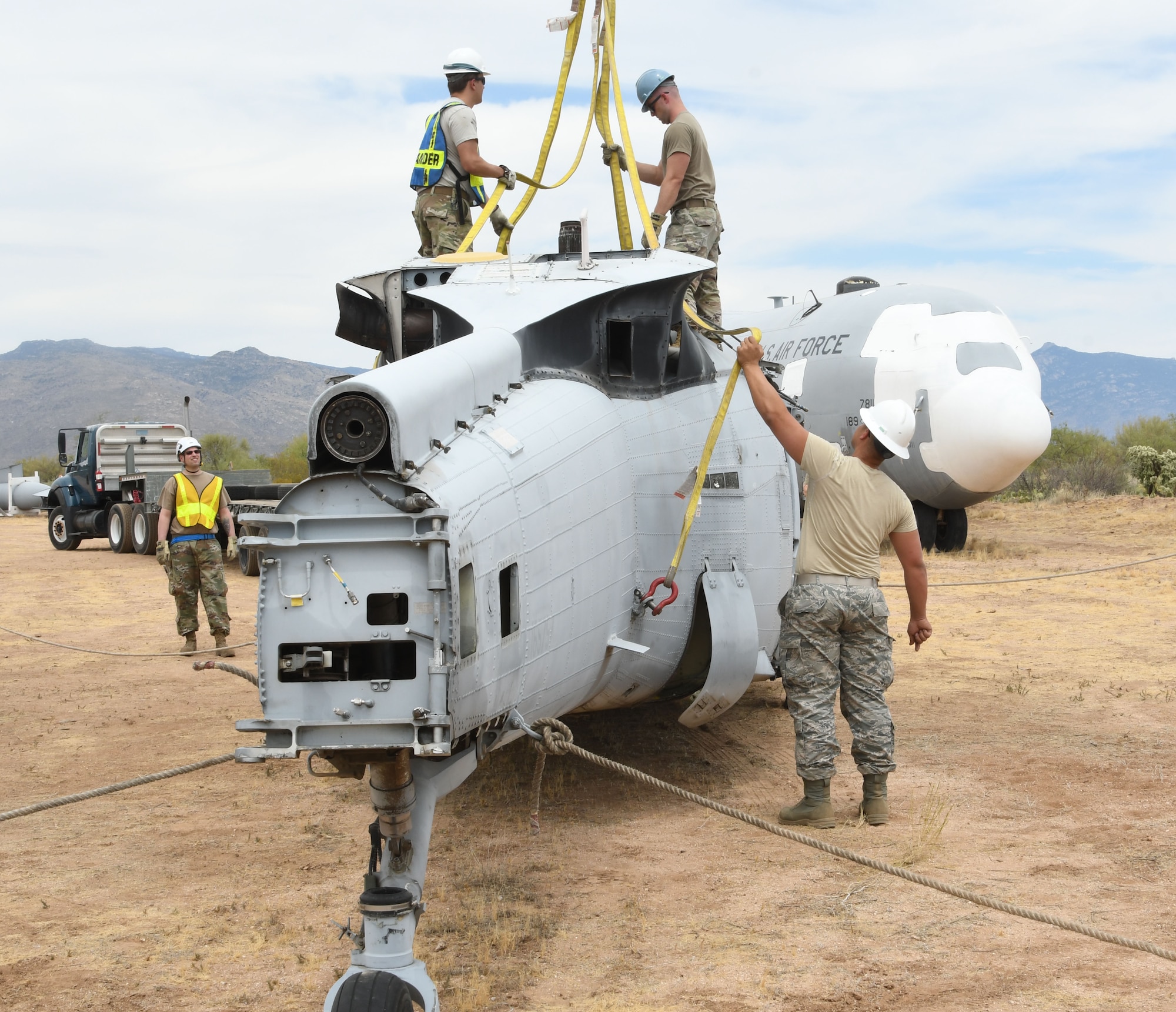Airmen prepare a helicopter.