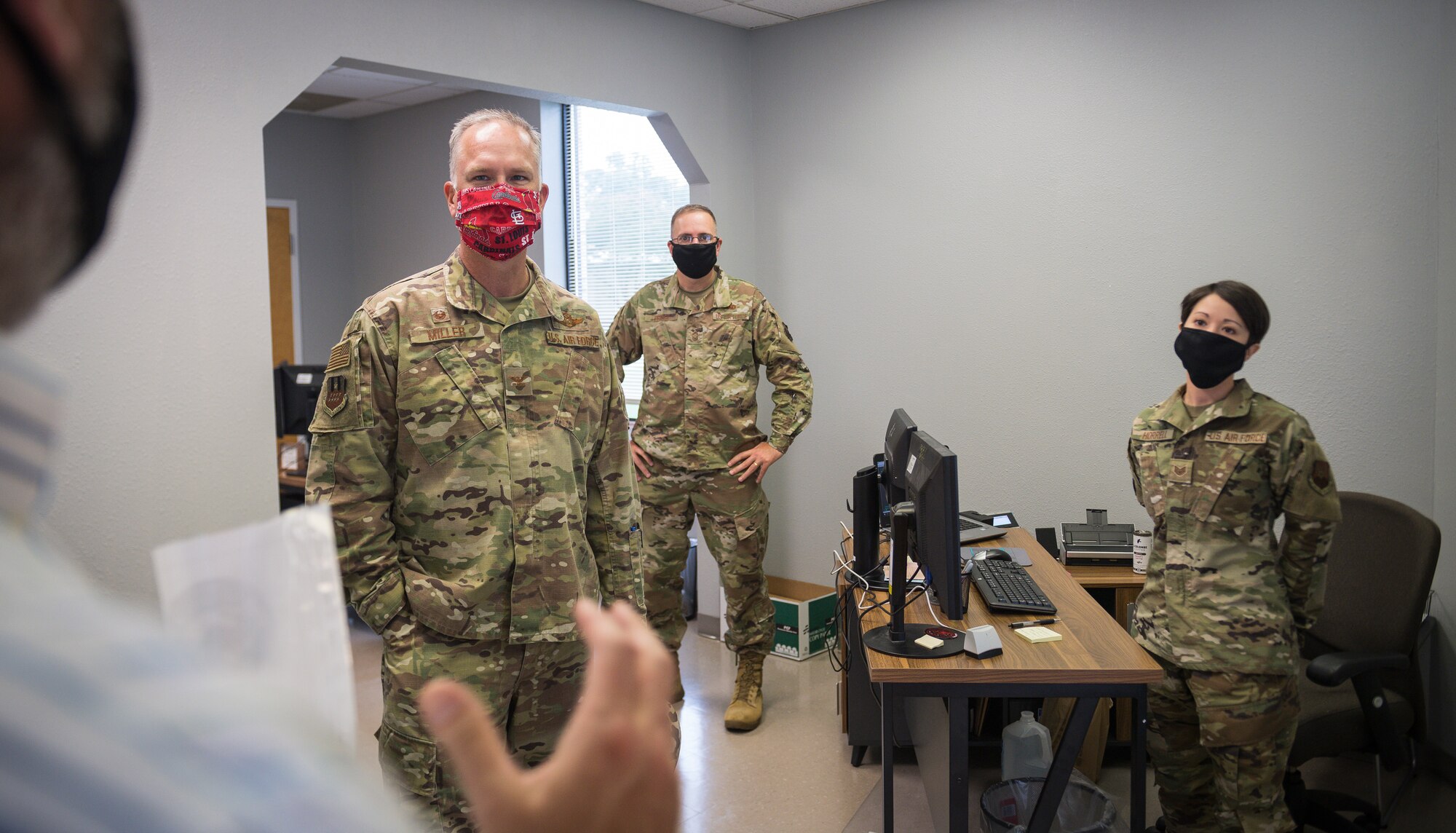 Col. Michael Miller, 2nd Bomb Wing commander, Chief Master Sgt. Jamie Prince, 2nd BW interim command chief, and Staff Sgt. Dylana Horrell, 2nd Comptroller Squadron financial operations supervisor, listen to Mr. Jeff Maiette, 2nd BW community support coordinator, as he briefs the functions of the new River’s Edge Welcome Center  at Barksdale Air Force Base, La., June 29, 2020.