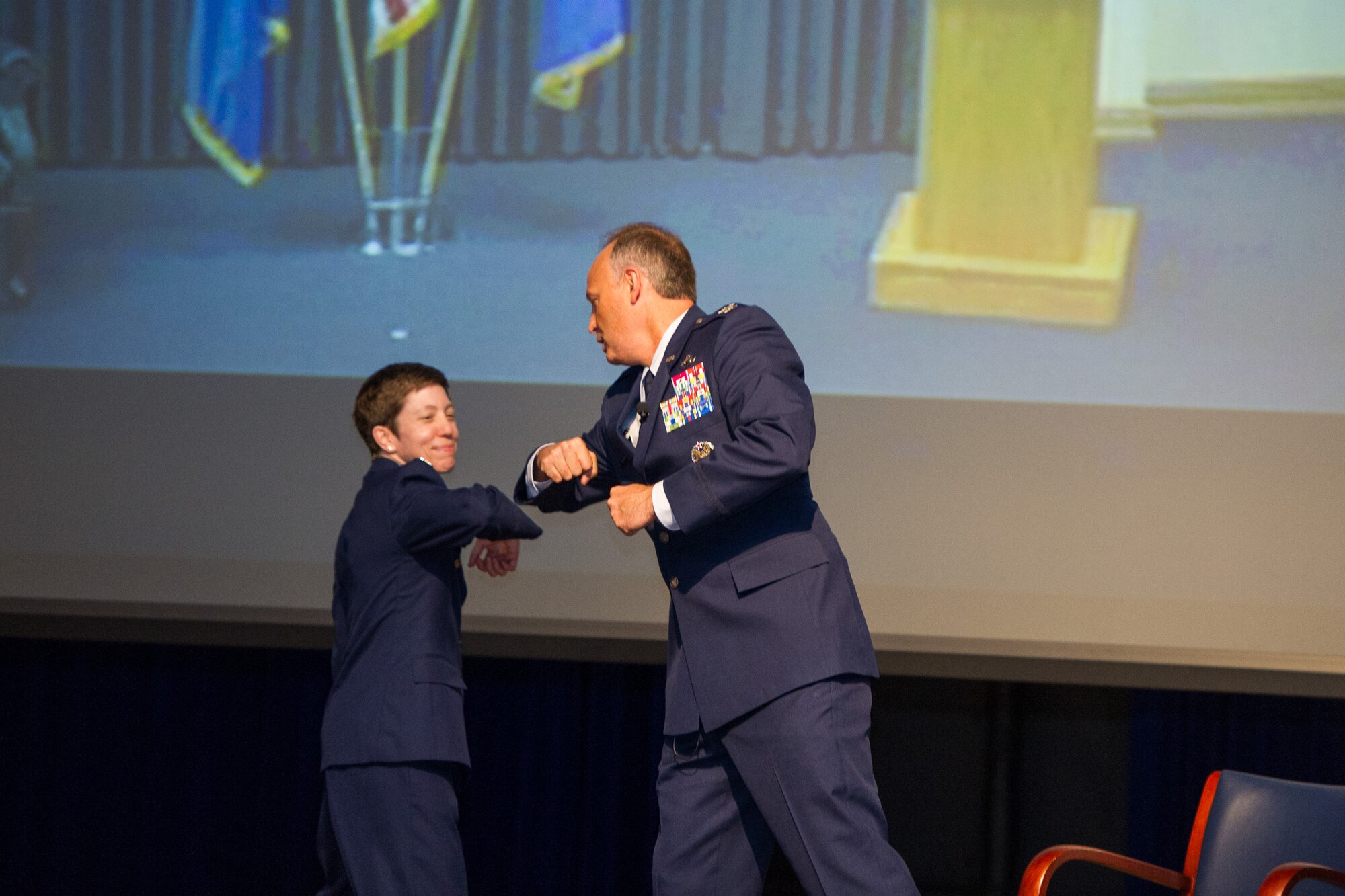 To avoid direct contact due to the coronavirus pandemic, incoming commander Col. Katharine Barber (left) bumps elbows with outgoing commander Col. Chad Hartman (right) in place of a handshake during the Air Force Technical Applications Center’s Change of Command ceremony June 30, 2020.  (U.S. Air Force photo by Amanda Ryrholm)