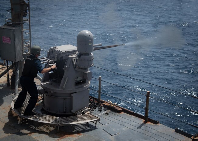Gunner's Mate 3rd Class Drew Krieger fires a Mark 38 25 mm machine gun system during a live-fire exercise, June 11.