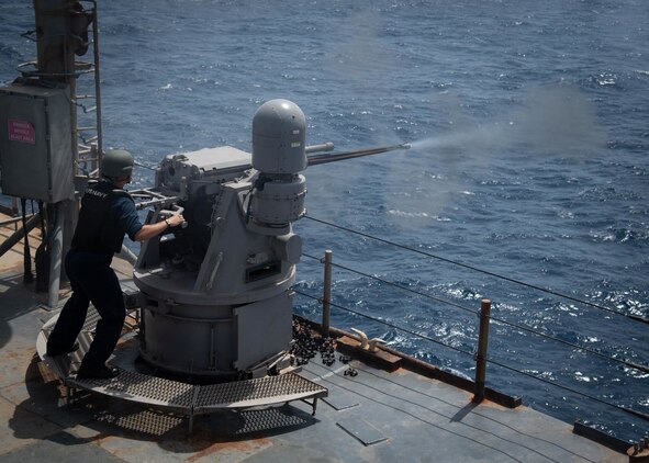 Gunner's Mate 3rd Class Drew Krieger fires a Mark 38 25 mm machine gun system during a live-fire exercise, June 11.