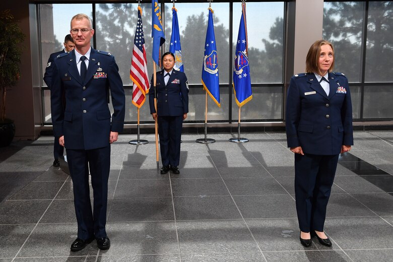 Col. Patrick Pohle, 21st Medical Group commander, left, and Lt. Col. Joanna Jaminska, incoming 21st Medical Squadron commander, participate in a change of command ceremony June 29, 2020, at Schriever Air Force Base, Colorado. Jaminska took command of the 21st MDS, which is responsible for providing medical services to Schriever Airmen. Jaminska is coming from Maxwell AFB, Alabama, where she was a student in the U.S. Air Force Air War College.  (U.S. Air Force photo by Dennis Rogers)
