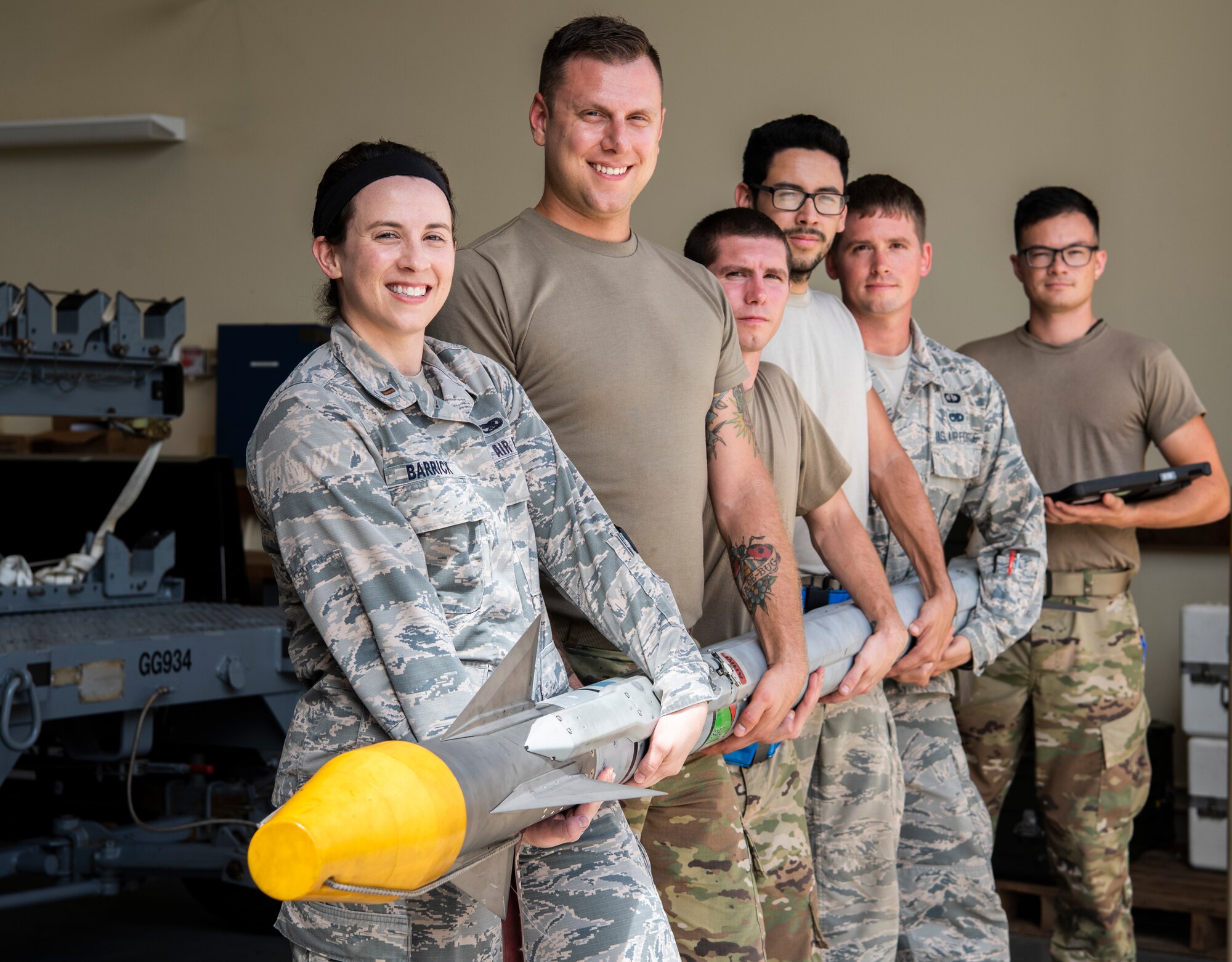 U.S. Air Force 2nd Lt. Megan Barrick, 36th Munitions Squadron (MUNS), Flight Commander, stands with her Airmen, Feb. 27 2020, at Andersen Air Force Base, Guam.