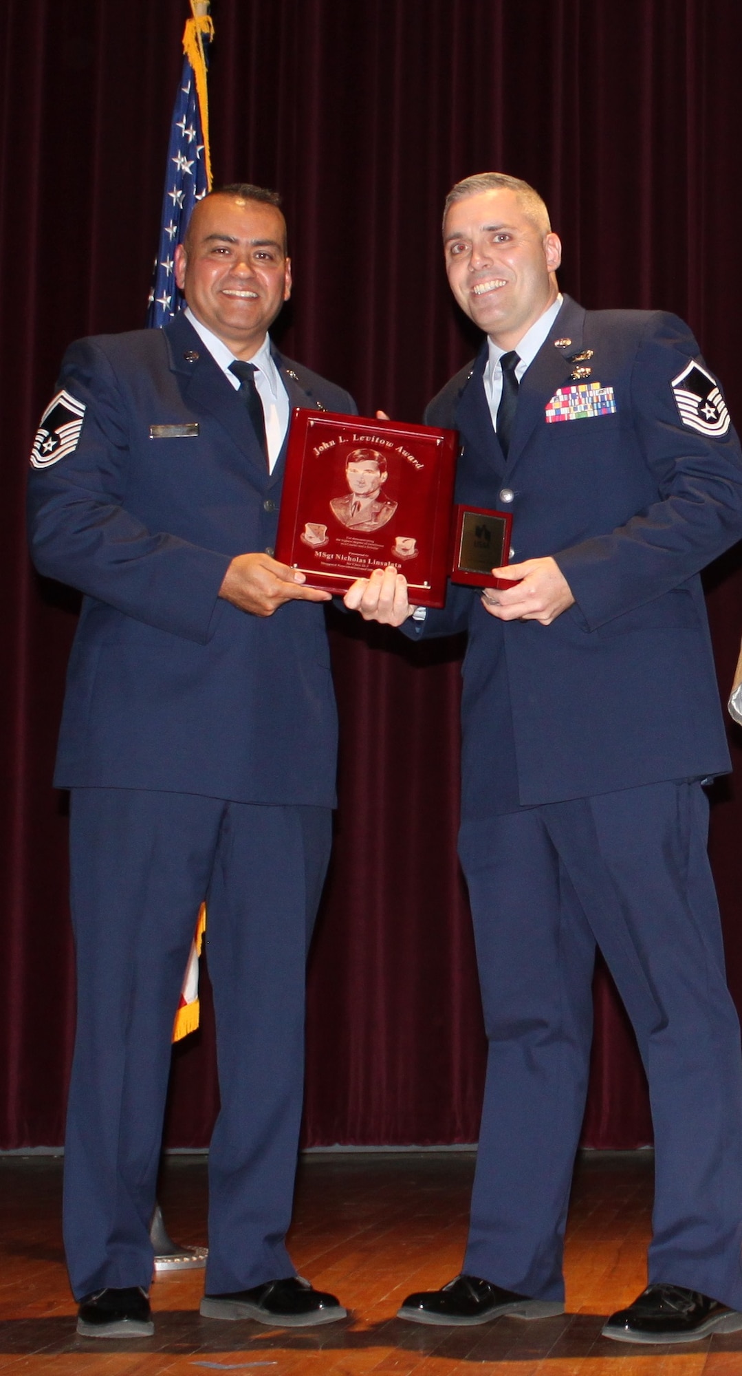 Office of Special Investigations Special Agent Nicholas Linsalata accepts the John L. Levitow Award from Senior Master Sgt. Jason A. Ramon, Sheppard Air Force Base, Texas, Noncommissioned Officer Academy Director of Education, during ceremonies Feb. 21, 2020, for the largest NCOA graduating class in history, 304 students. (Sheppard NCOA photo)