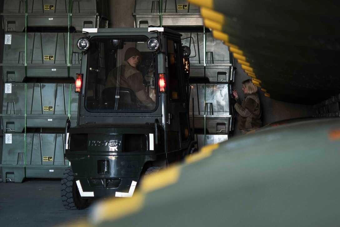 U.S. Air Force Airman 1st Class Matt Amato, 86th Munitions Squadron munitions stockpile management technician, operates a forklift while moving containers of inert munitions components into a storage facility at Ramstein Air Base, Germany, Feb. 6, 2020. The 86th MUNS received their largest shipment of munitions in 20 years. (U.S. Air Force photo by Staff Sgt. Devin Nothstine)